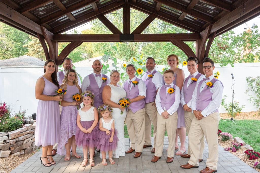 Same sex couple and their wedding party at their backyard Westland wedding