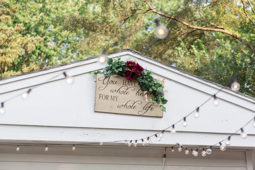 Wooden sign that says, "You have my whole heart for my whole life" at backyard Westland wedding