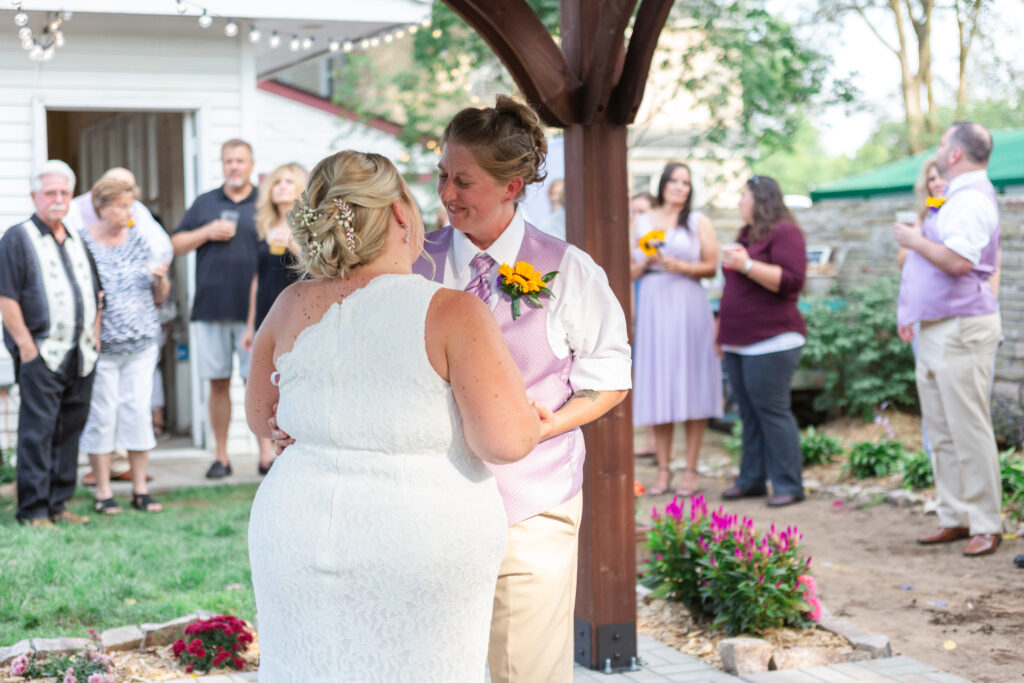 First dance between wife and wife at their backyard Westland wedding