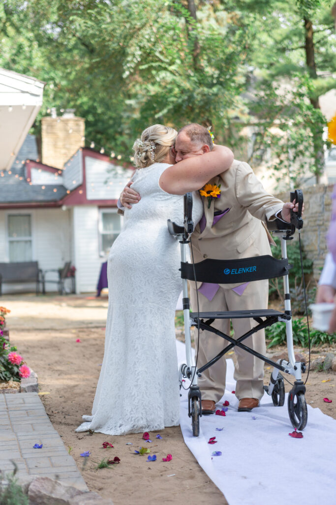 Bride hugging father as he gives her away at their Westland wedding