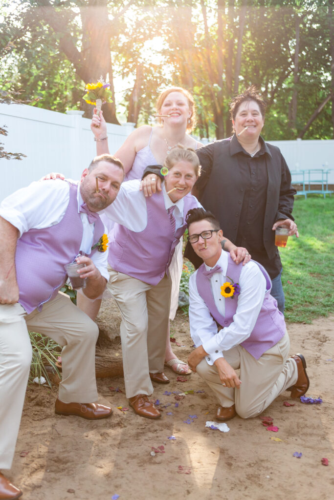 Bride with wedding party posing with cigars in their mouth at Westland wedding