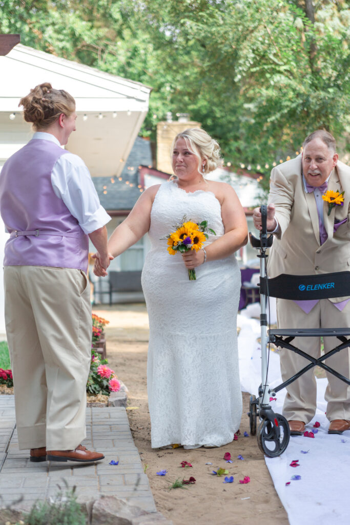 Bride tearfully joins hands with soon to be wife at their Westland wedding