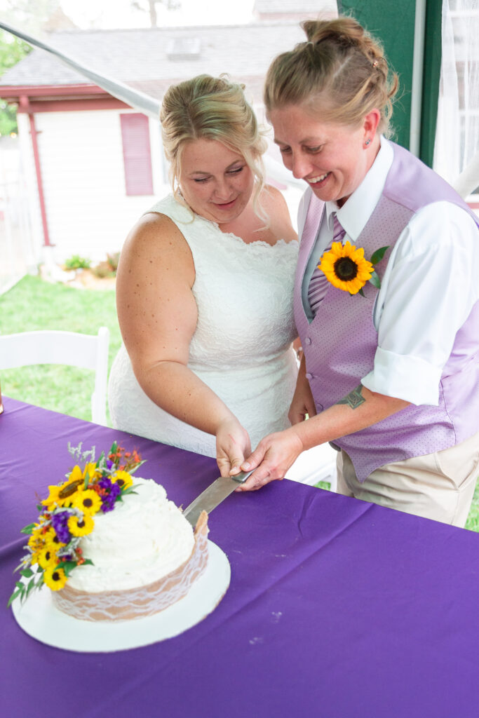 Two brides cutting the wedding cake Westland wedding