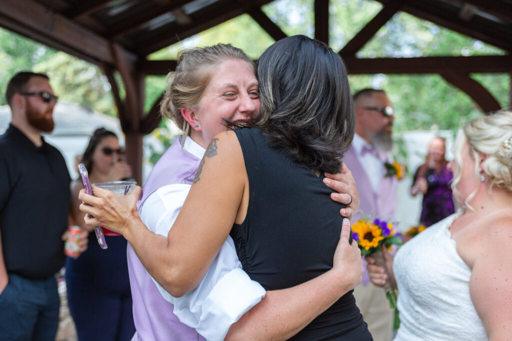 Bride embraces guest at her Westland wedding