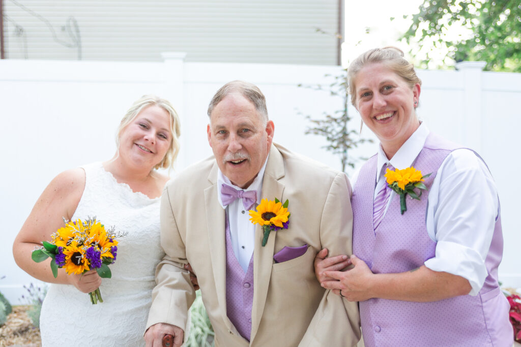 Both bride's with Amanda's father at their Westland wedding