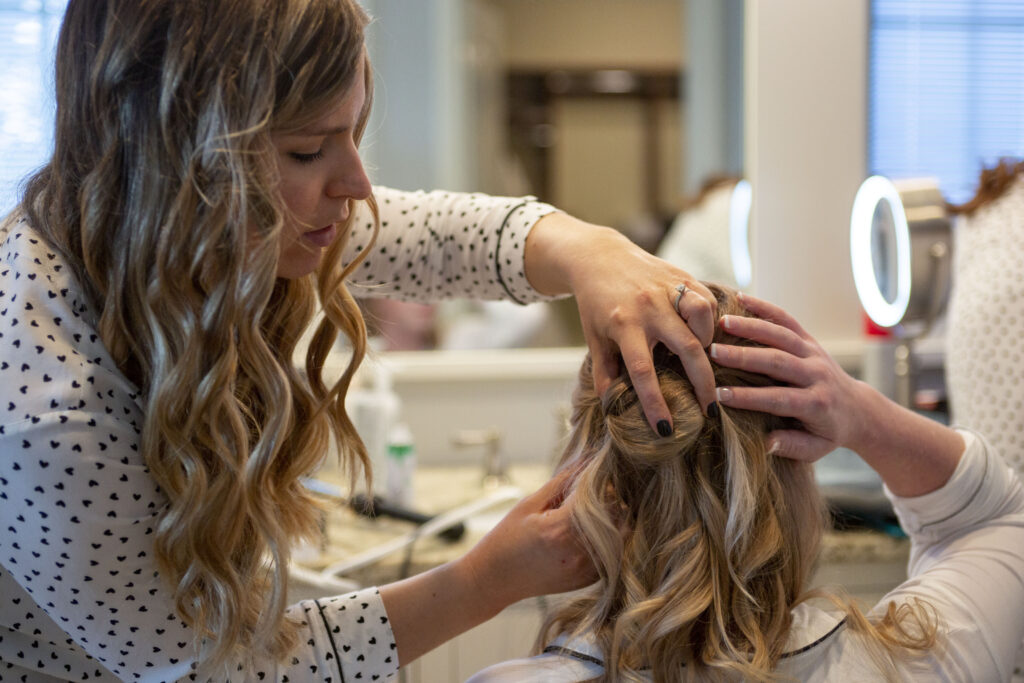 Bride getting her hair done for her west Michigan AirBNB wedding