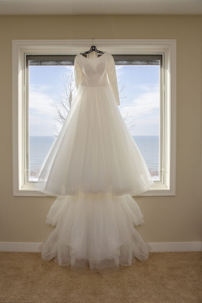 Wedding dress overlooking Lake Michigan at AirBNB wedding