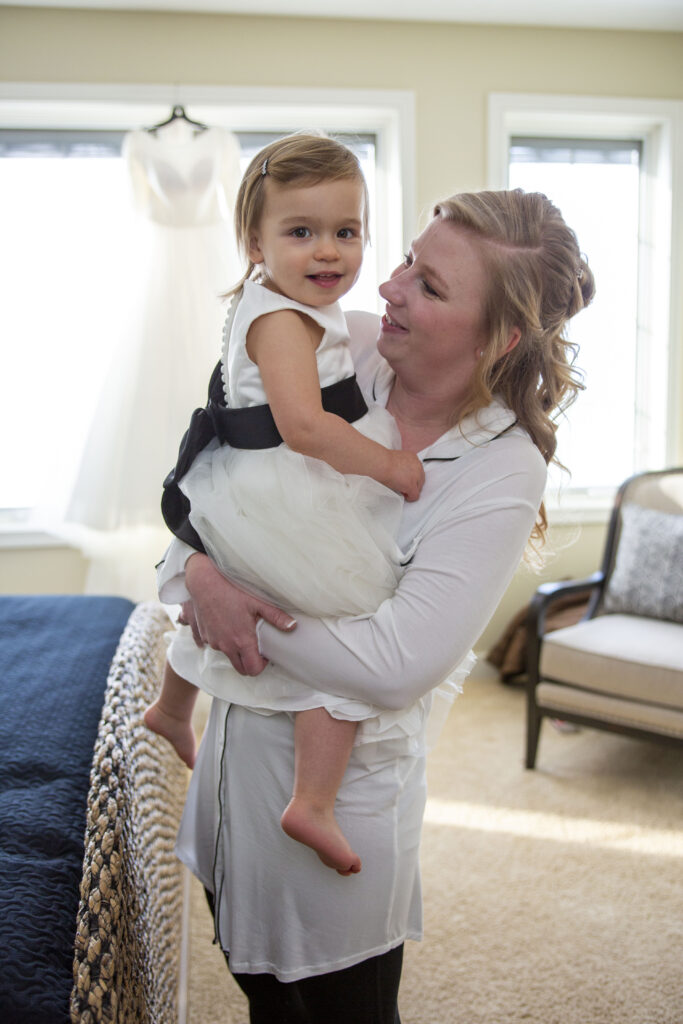 Bride and flower girl before her Michigan AirBNB wedding