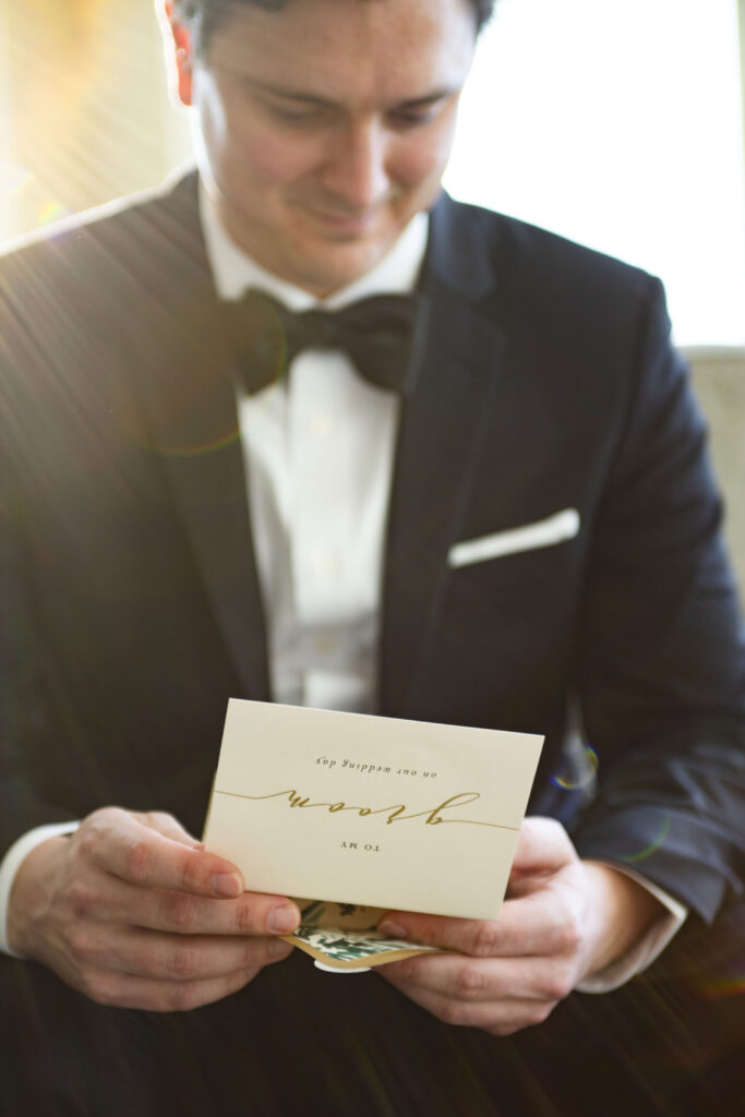 Groom reading his card from his bride before their Michigan AirBNB wedding