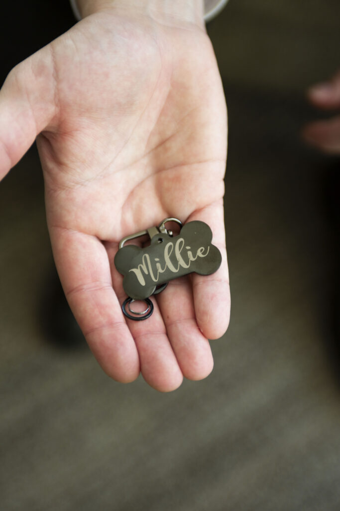 Dog tag inscribed with their dog's name and their married last name AirBNB wedding