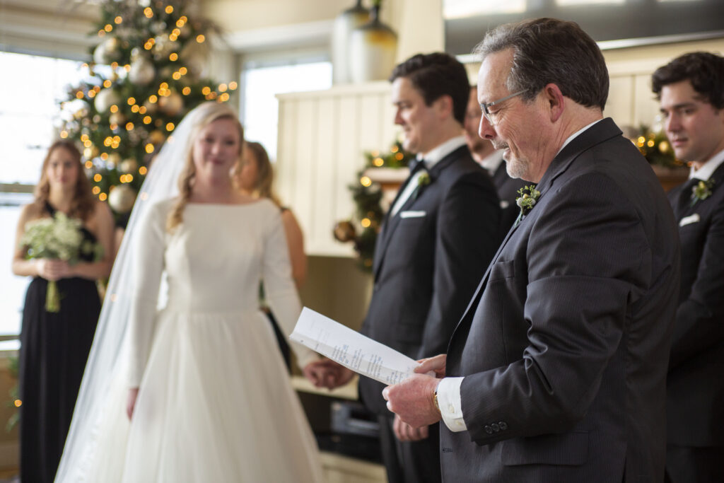 Father of the groom reading a verse during Michigan AirBNB wedding