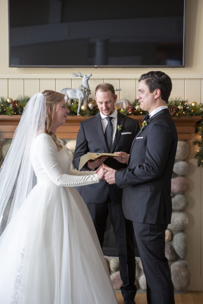 Couple holding hands at the altar of their Michigan AirBNB wedding