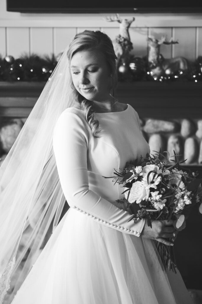 Bride looking down in black and white AirBNB wedding