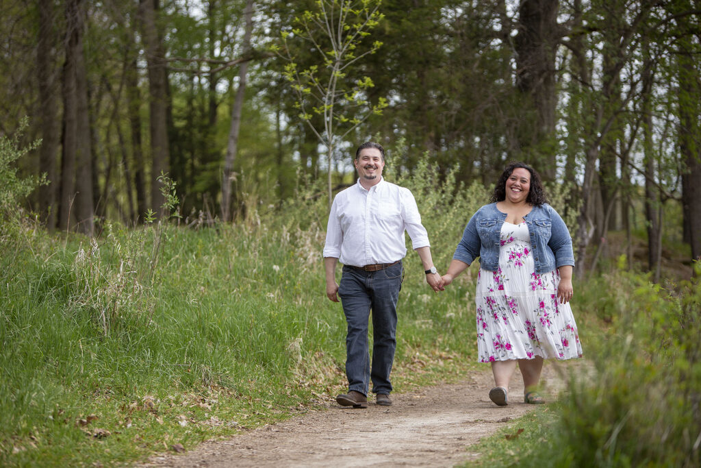 Couple walking together on unpaved path Kensington Metropark engagement photos