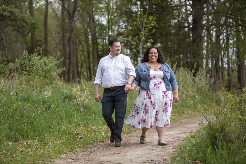 Strolling along dirt path and laughing during Kensington Metropark engagement photos