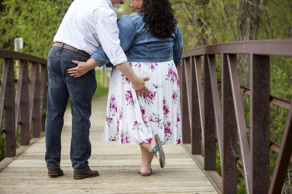 Color version of couple grabbing each other butts on bride during Kensington Metropark engagement session