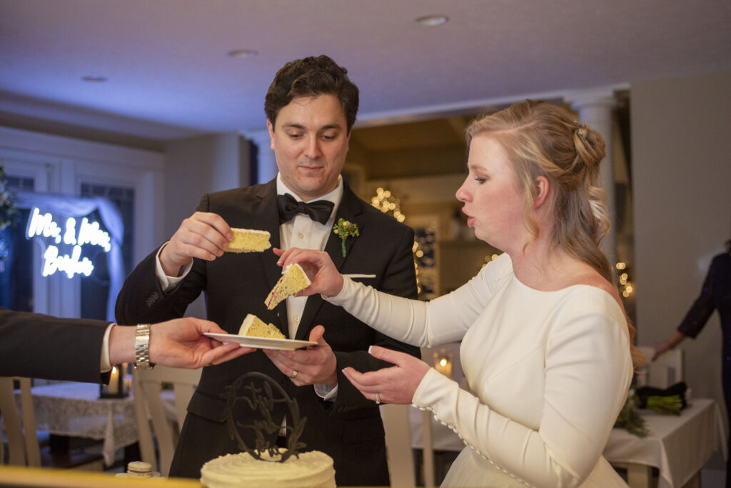 Cutting of the cake at west Michigan AirBNB wedding