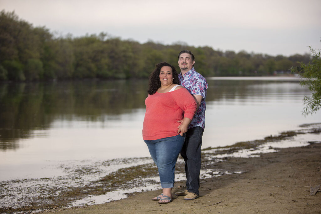 Couple with lake in the background at their Kensington Metropark engagement photos