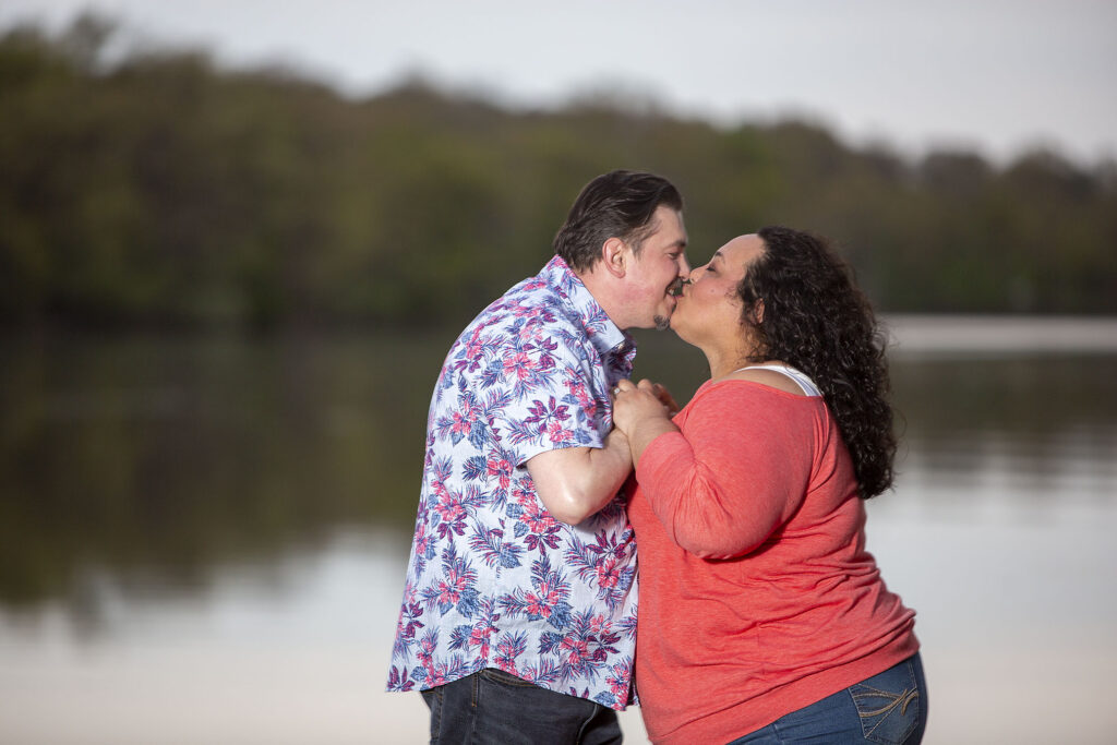 Sally and Mel kissing as the sun sets during their Kensington Metropark engagement session