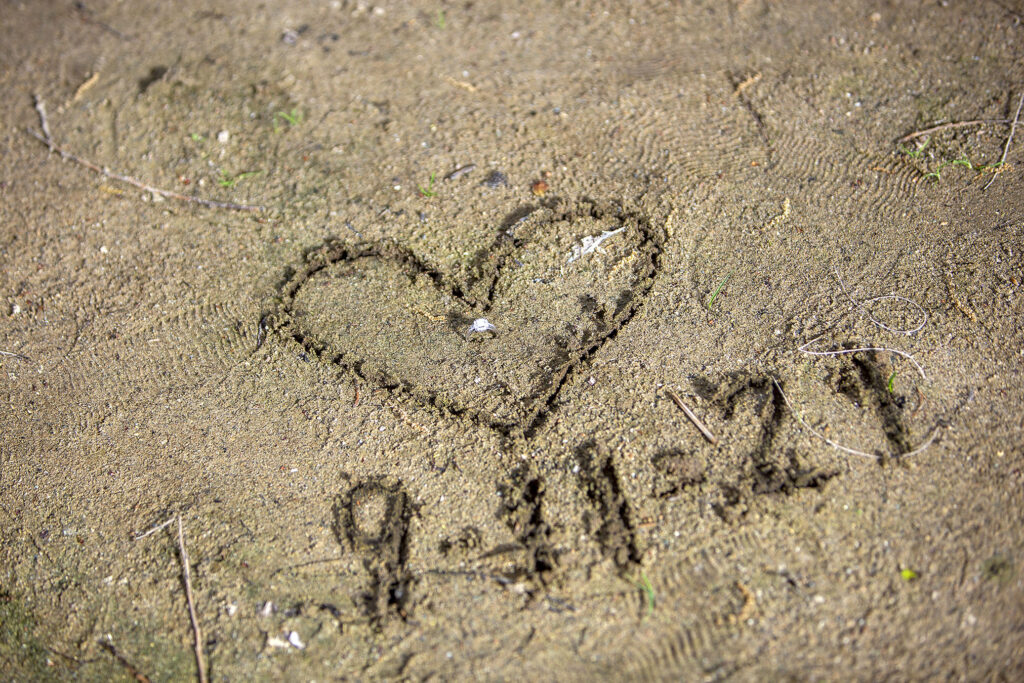 Color version of heart and 9-11-21 drawn in sand during Kensington Metropark engagement session