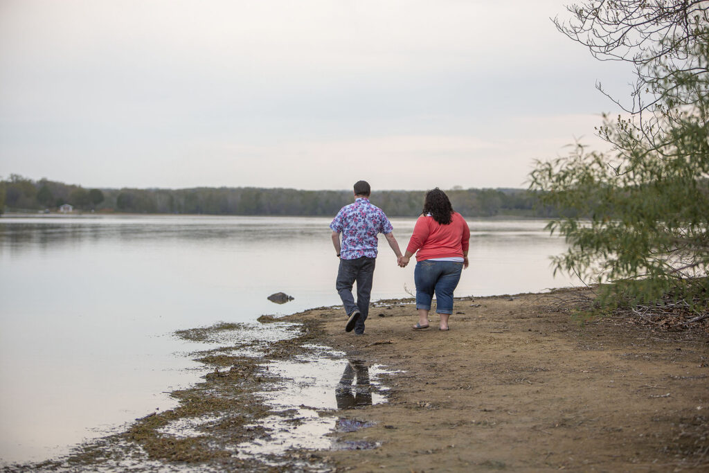 Michigan couple holding hands during Kensington Metropark engagement session