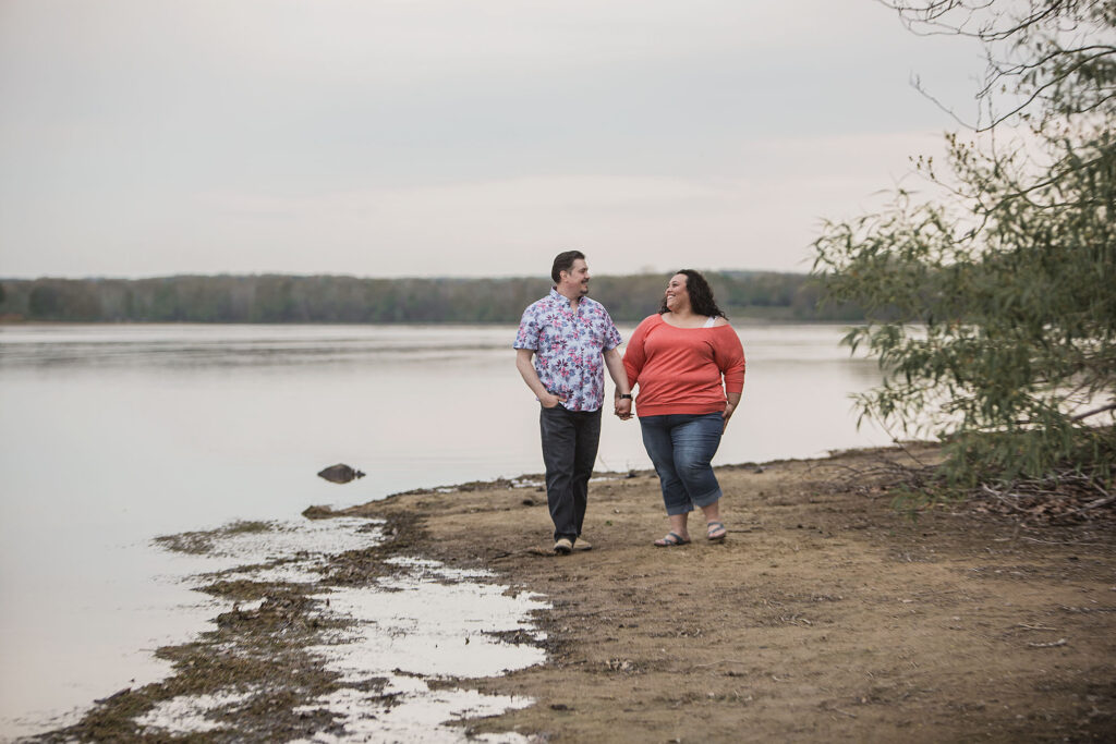 Couple walking along the beach during Kensington Metropark engagement session