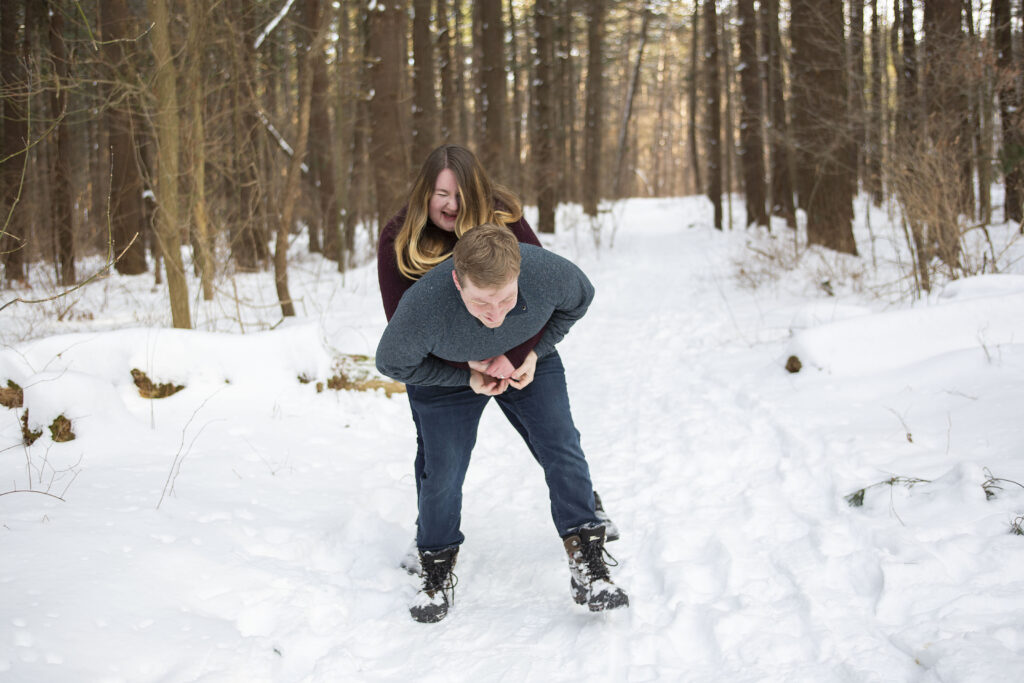 Jerry gives Sara a piggyback ride during winter couple's photos