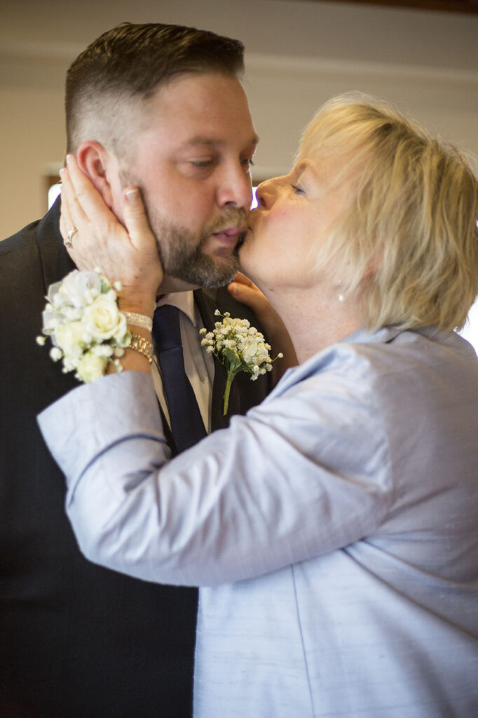 Mom kisses groom before his Plymouth wedding