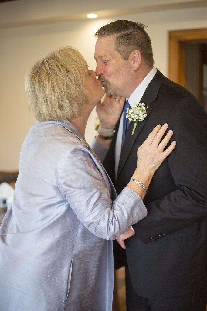 Mom and dad kissing before the Plymouth wedding