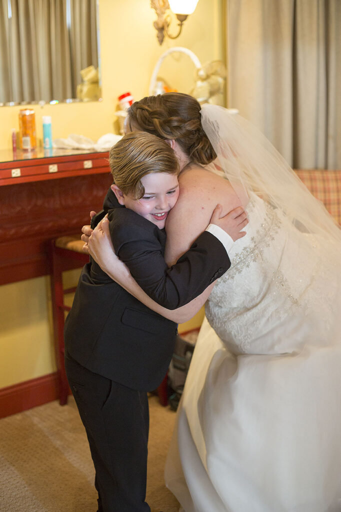 Son hugging mother before Plymouth wedding