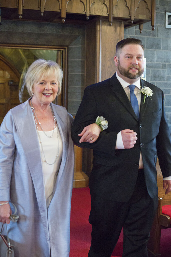 Groom and mother walking down the aisle at the Plymouth wedding