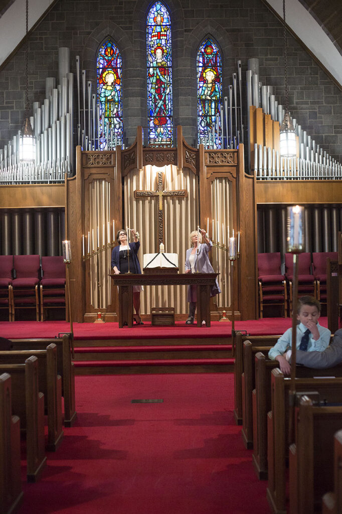 Mother's lighting the candles at the altar during Plymouth wedding