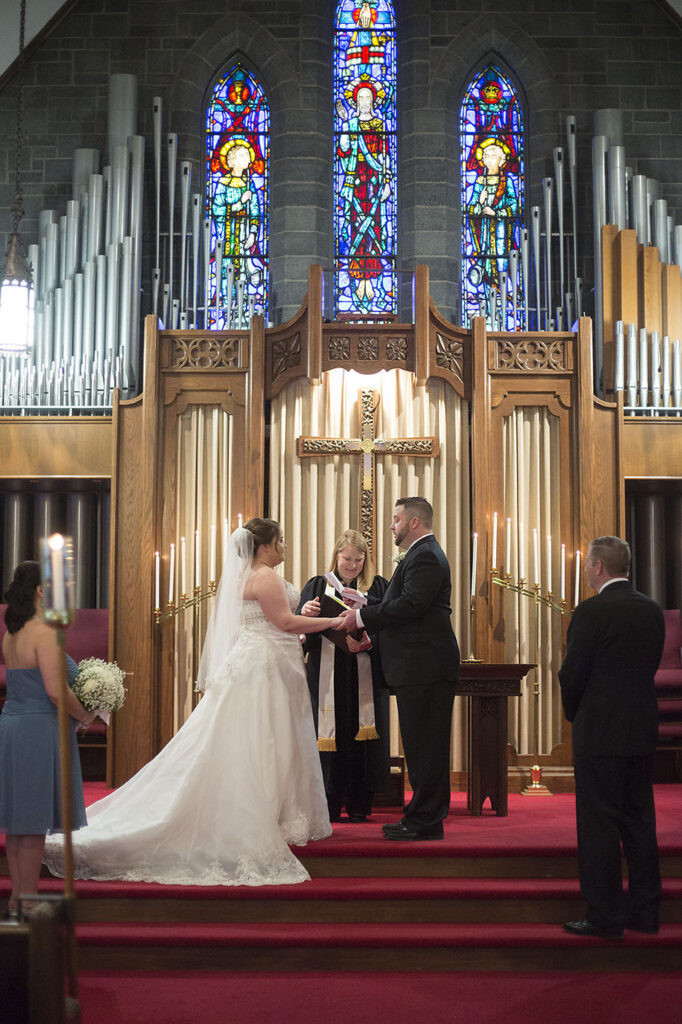 Plymouth wedding exchanging vows in front of church organ