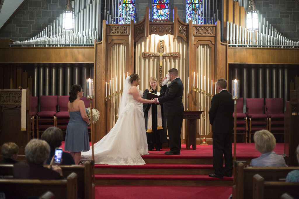 Groom wiping tears from his eyes as he recites his vows at his Plymouth wedding