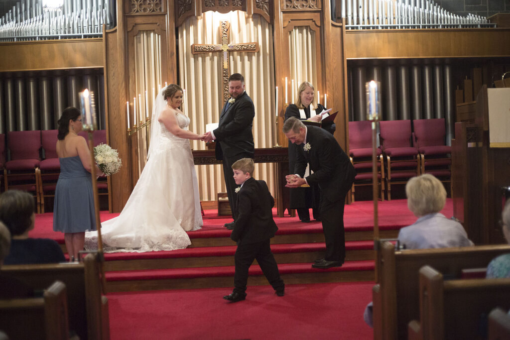 Ring bearer handing off the rings at Plymouth wedding