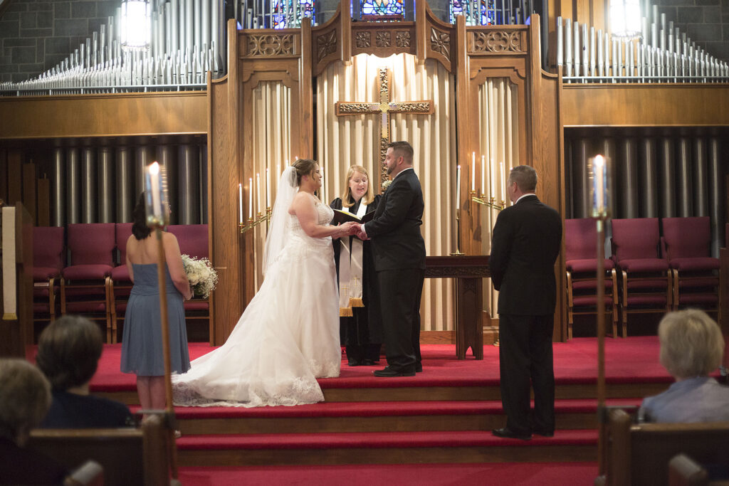 Bride and groom holding hands at Plymouth wedding