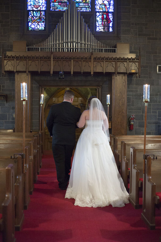 Bride and groom walking down the aisle at Plymouth wedding