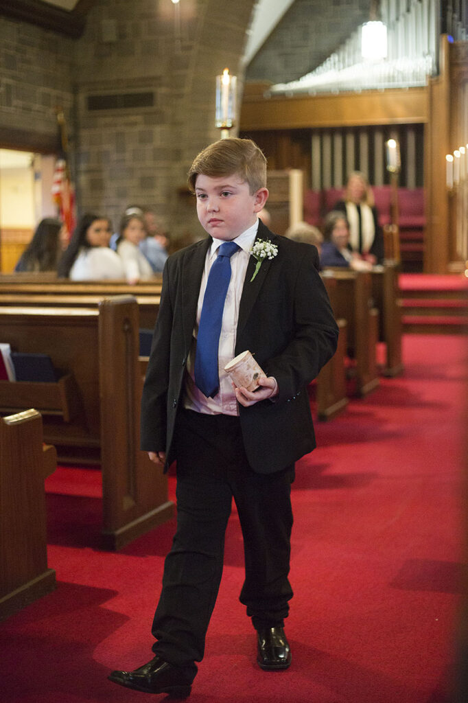 Bride's son and ring bearer walking down the aisle at Plymouth wedding