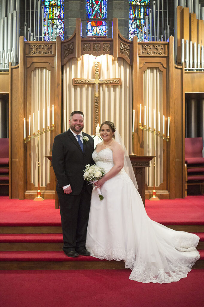 Plymouth wedding couple standing in front of organ