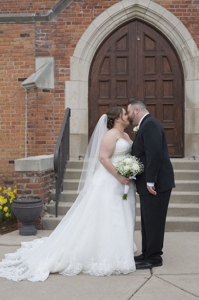 Plymouth wedding bride and groom kissing in front of Presbyterian church