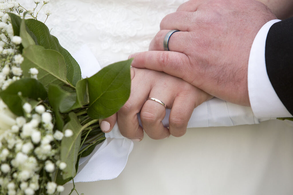 Bride and groom's hands with wedding rings Plymouth wedding