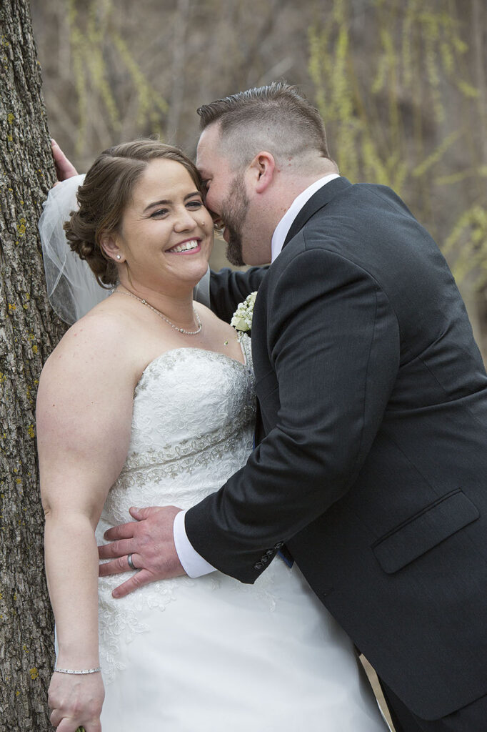 Plymouth wedding couple, Danielle and Nick cuddle in close