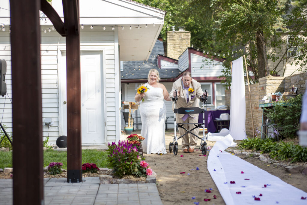 Bride walks down the aisle with her father at her Westland wedding