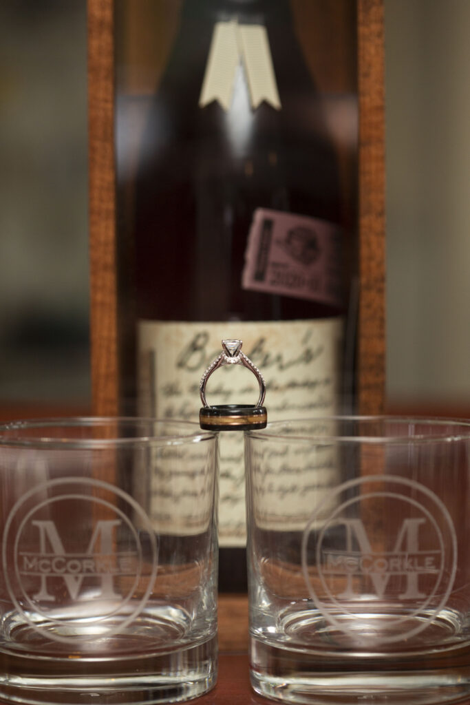 Wedding rings balancing on top of custom engraved whiskey glasses at Westland wedding