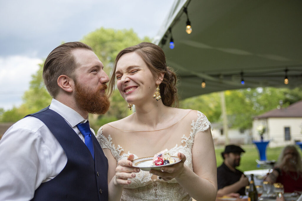 Couple laughing during Michigan micro wedding cake cutting