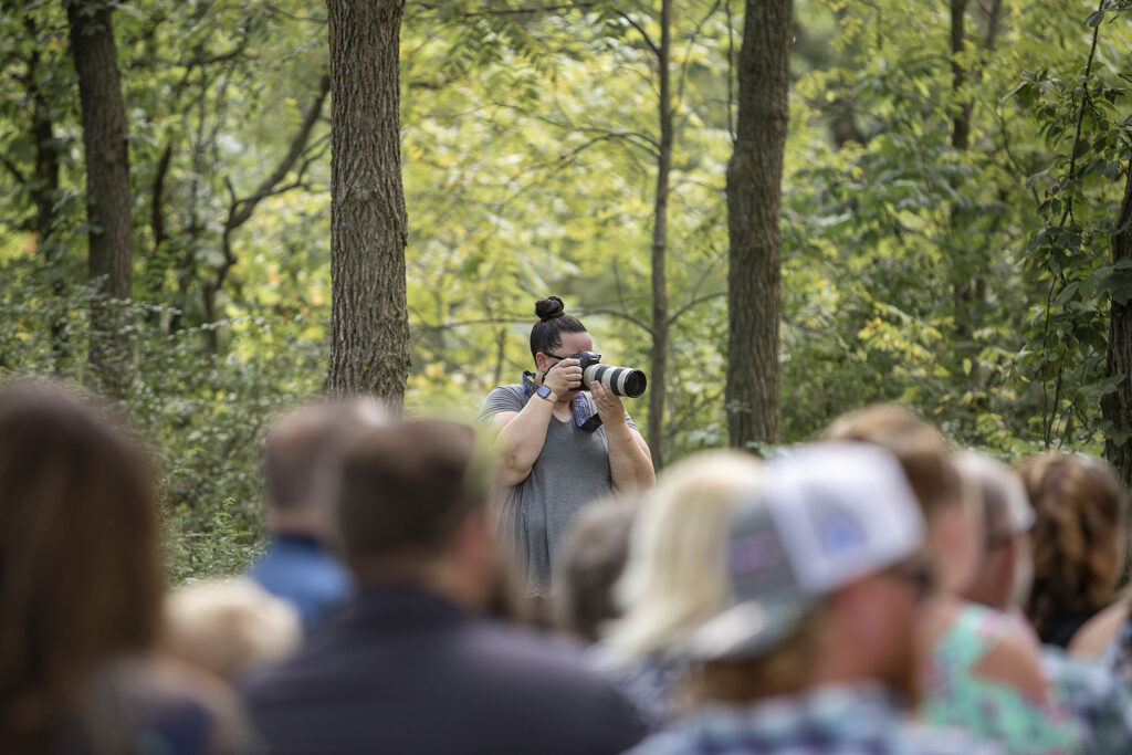 Michigan wedding photographer, Natalie Mae, photographing a couple during their ceremony