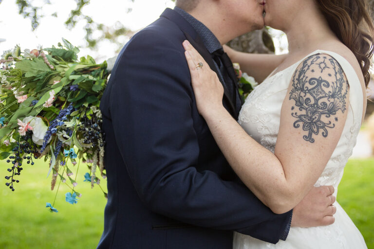 Ann Arbor micro wedding couple kisses outside of hotel