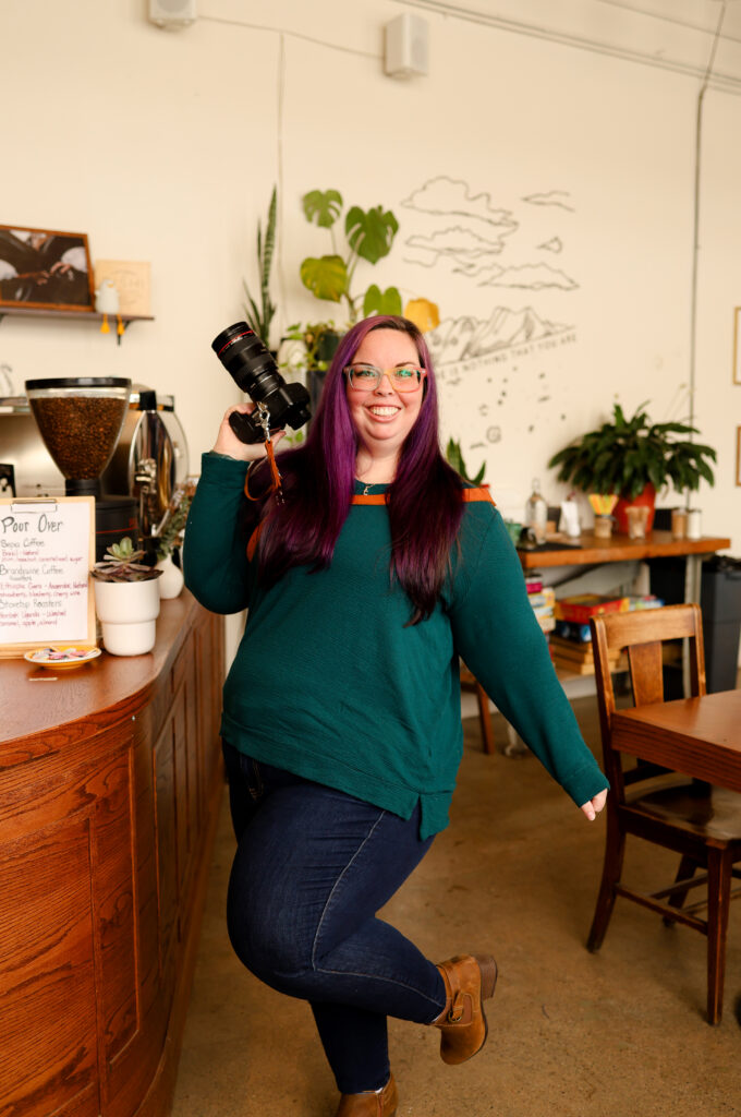 Ann Arbor wedding photographer Natalie Mae dances in a coffee shop.