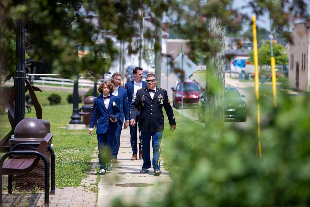 Belleville Michigan groom and groomsmen walk towards the ceremony site.