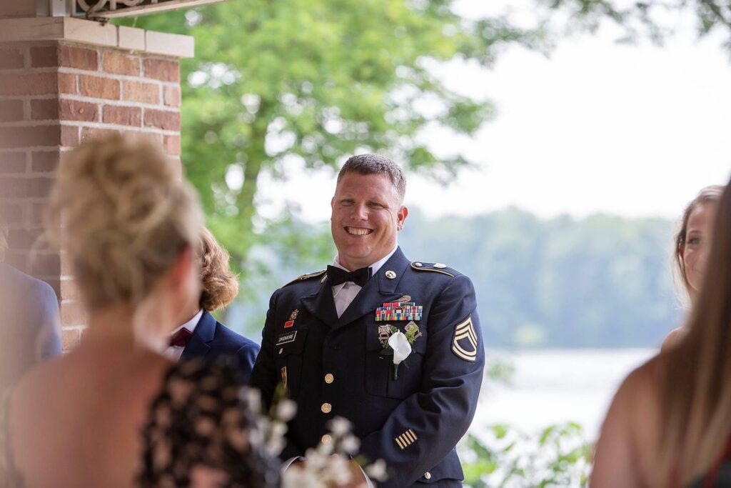 Belleville Michigan groom smiling ear-to-ear as his bride walks down the aisle.